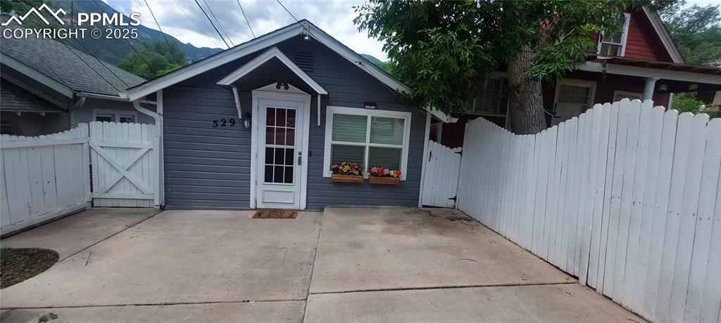 Image 3 of 46: front with patio featuring a gate