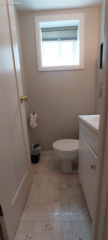 Image 34 of 46: Lower level 1/2 bathroom with toilet and vanity