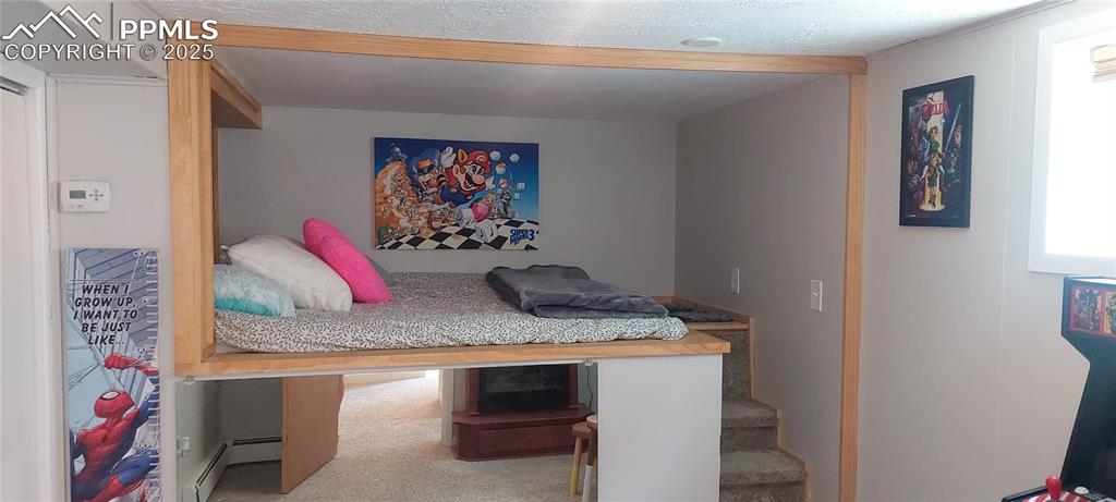 Image 36 of 46:  2nd Bedroom featuring baseboard heating and carpet flooring