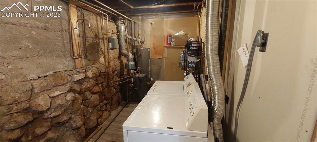 Image 40 of 46: View of lower level laundry area and Boiler, HW heater and open showerarea