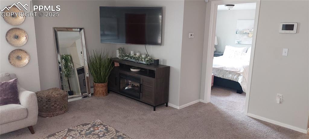 Image 9 of 46: Living room featuring carpet floors and baseboards