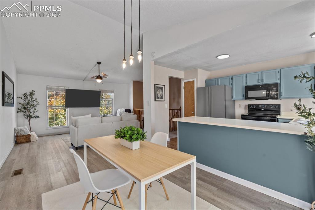 Image 10 of 29: Dining room featuring light wood finished floors and recessed lighting