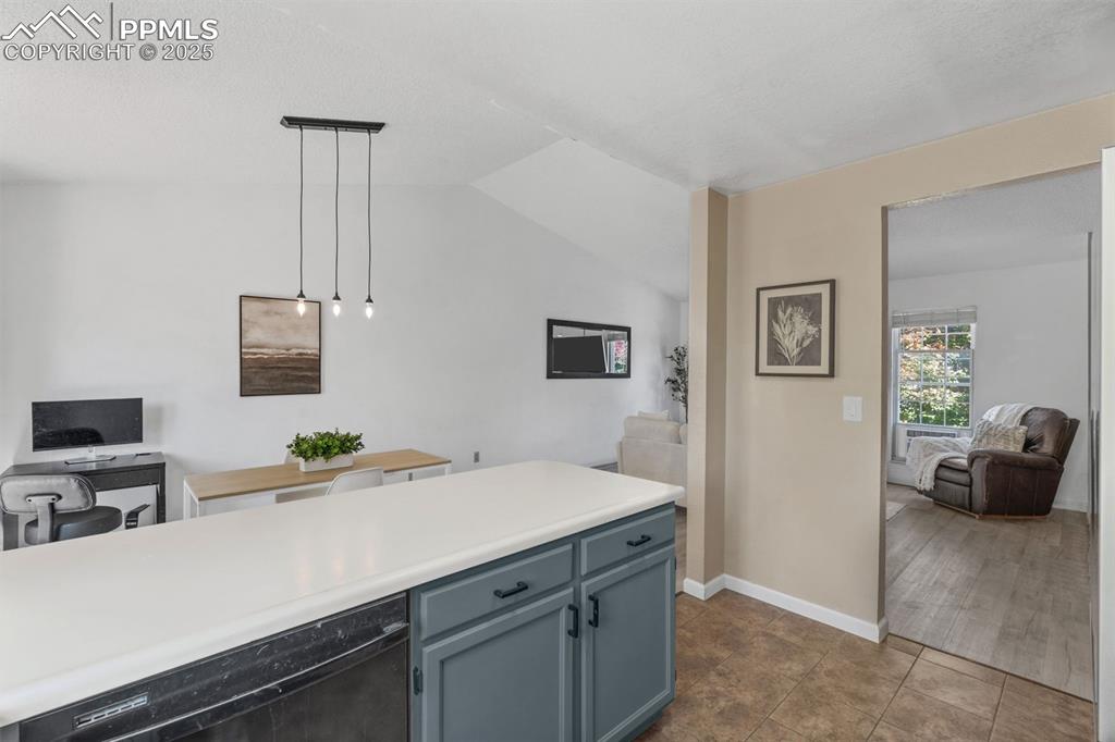Image 13 of 29: Kitchen featuring light countertops, hanging light fixtures, dishwasher, op