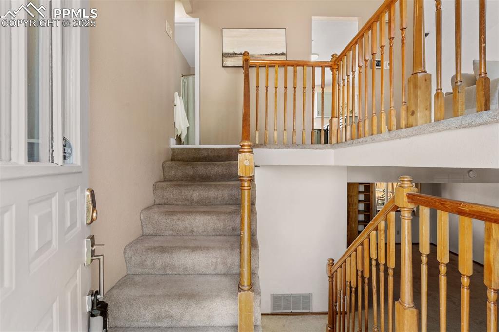 Image 3 of 29: Stairway with carpet floors