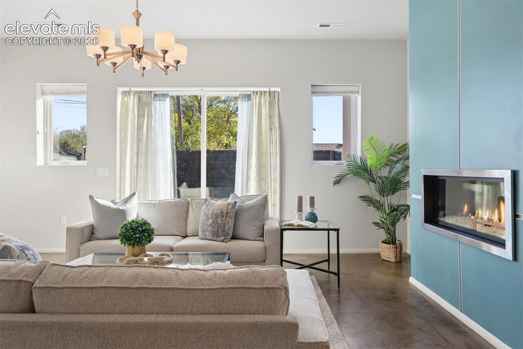 Image 10 of 45: Living room with walkout and fireplace