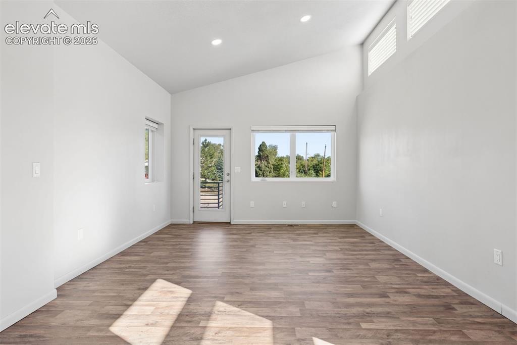 Image 28 of 45: The front bedroom has LVP flooring and a separate entrance