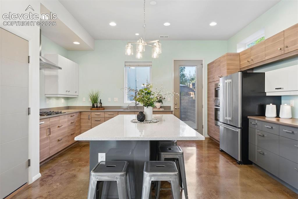 Image 3 of 45: A fantastic open kitchen with massive island, wall oven, gas range and exte