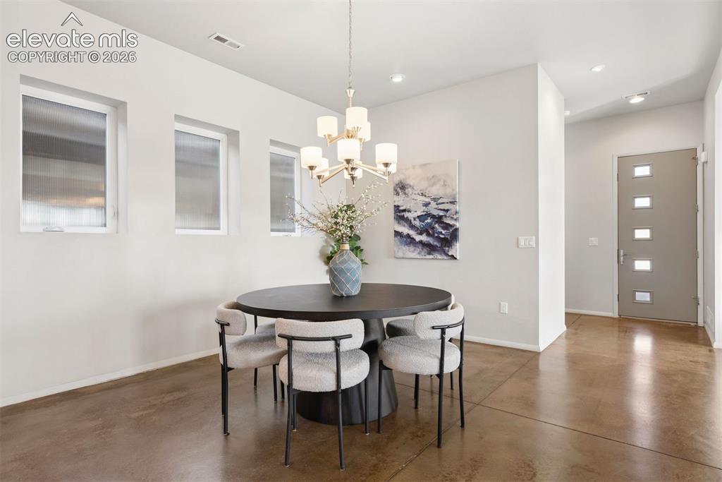 Image 38 of 45: Dining room to entry showcasing the 8