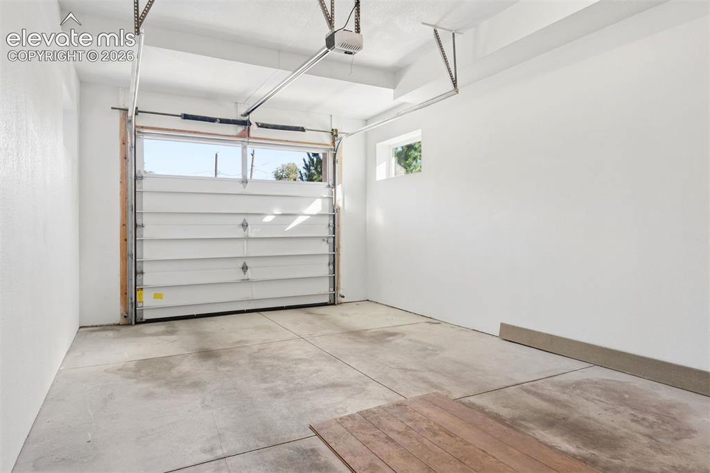 Image 41 of 45: Front one-car garage (2 one-cars at property) with 9