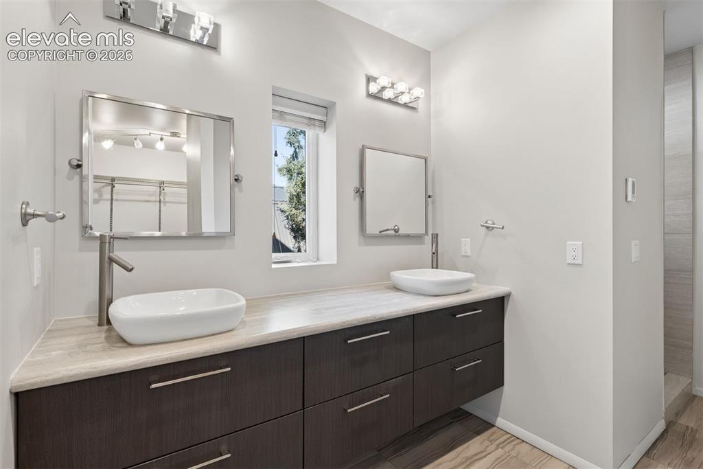 Image 5 of 45: Primary bath with double vanities and shower