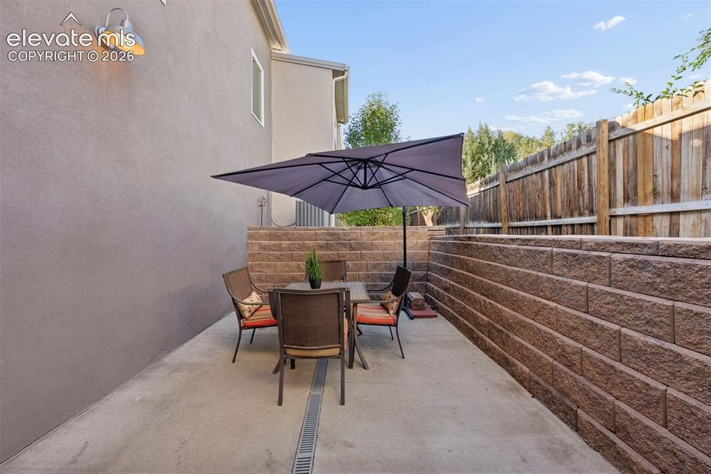 Image 8 of 45: Back patio is private and discreet