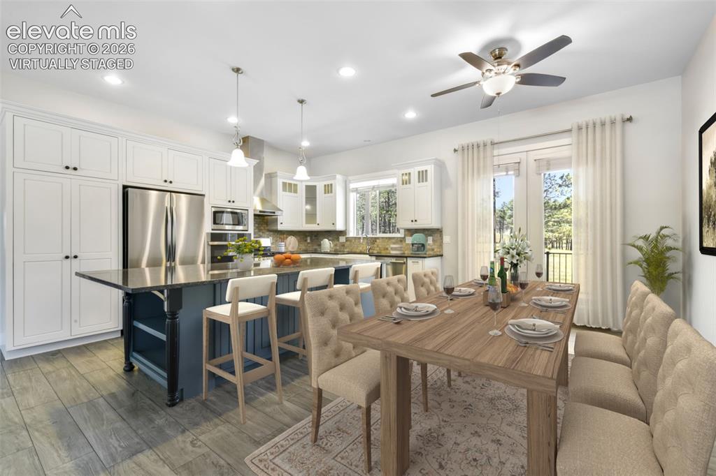 Image 15 of 50: Open kitchen and dining virtually staged