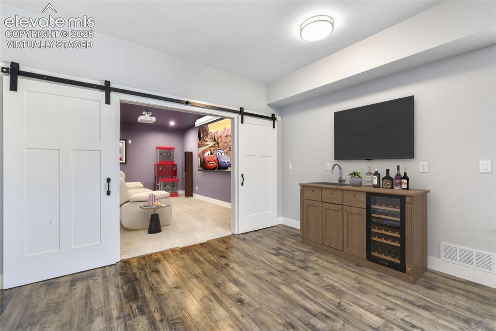 Image 33 of 50: Huge family room for entertaining in basement virtually staged