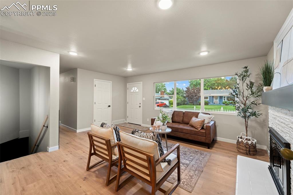 Image 13 of 31: Living room featuring baseboards, light wood-type flooring, recessed lighti