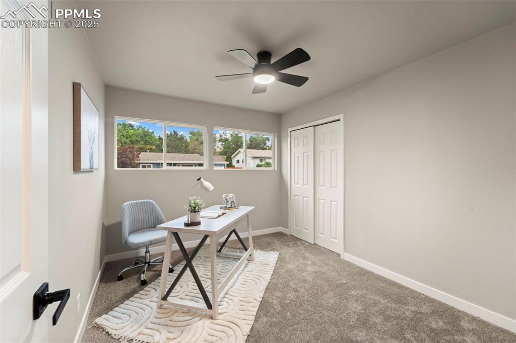 Image 21 of 31: Carpeted office space featuring ceiling fan and baseboards
