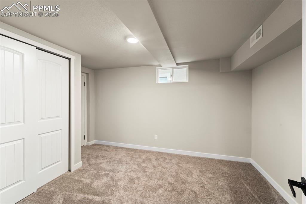 Image 23 of 31: Basement featuring carpet flooring and baseboards