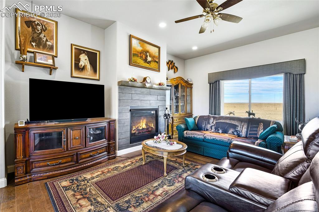 Image 13 of 49: Can Lighting, Large Windows, Gas Fireplace with Tile Surround and Mantel