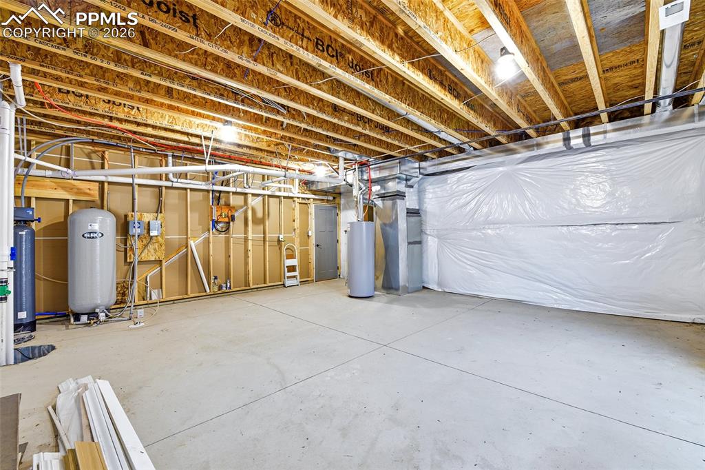 Image 34 of 49: Large Mechanical/Storage Area with Whole Home Water Filtration System