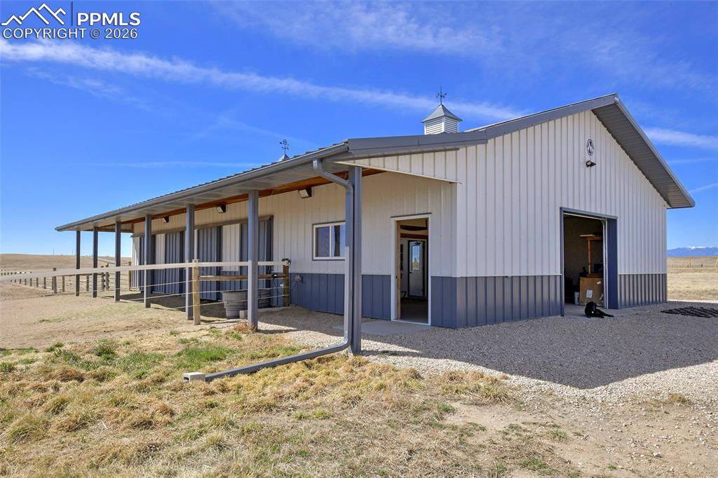 Image 39 of 49: Four Stall Barn with Overhang, Side Entry and Overhead Door.