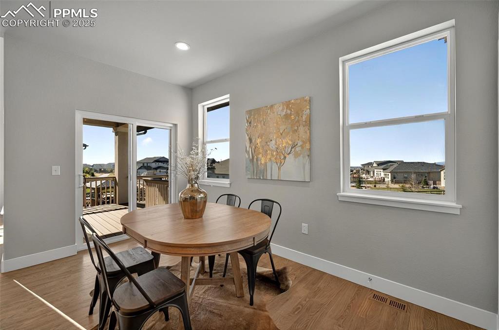 Image 14 of 49: Kitchen dining area with walk out to deck and more views!