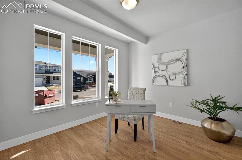 Image 20 of 49: Real wood flooring through the main level and into the office!