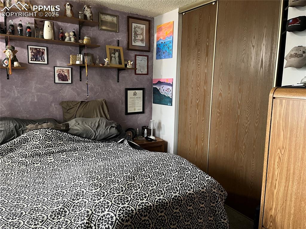 Image 12 of 17: Bedroom featuring a textured ceiling