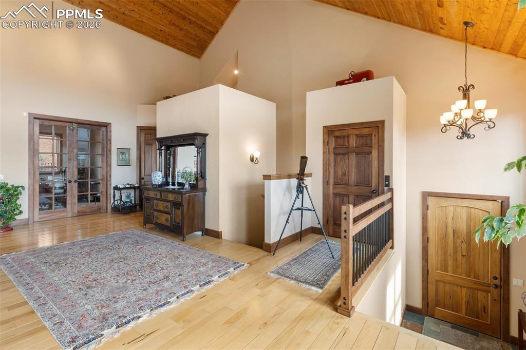 Image 21 of 47: Office with built ins and book shelves, french doors.