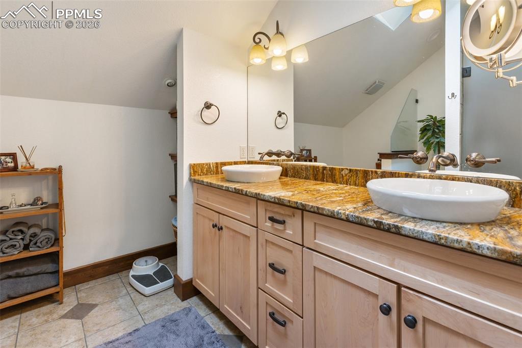 Image 29 of 48: Office with built ins and book shelves, french doors.