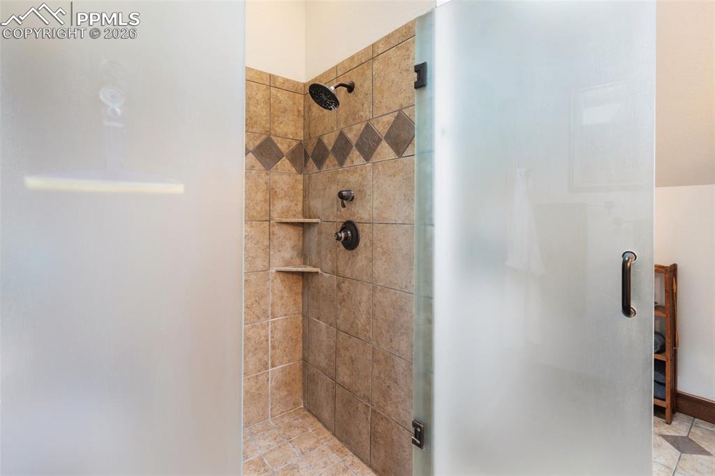 Image 30 of 48: Office with built ins and book shelves, french doors. 