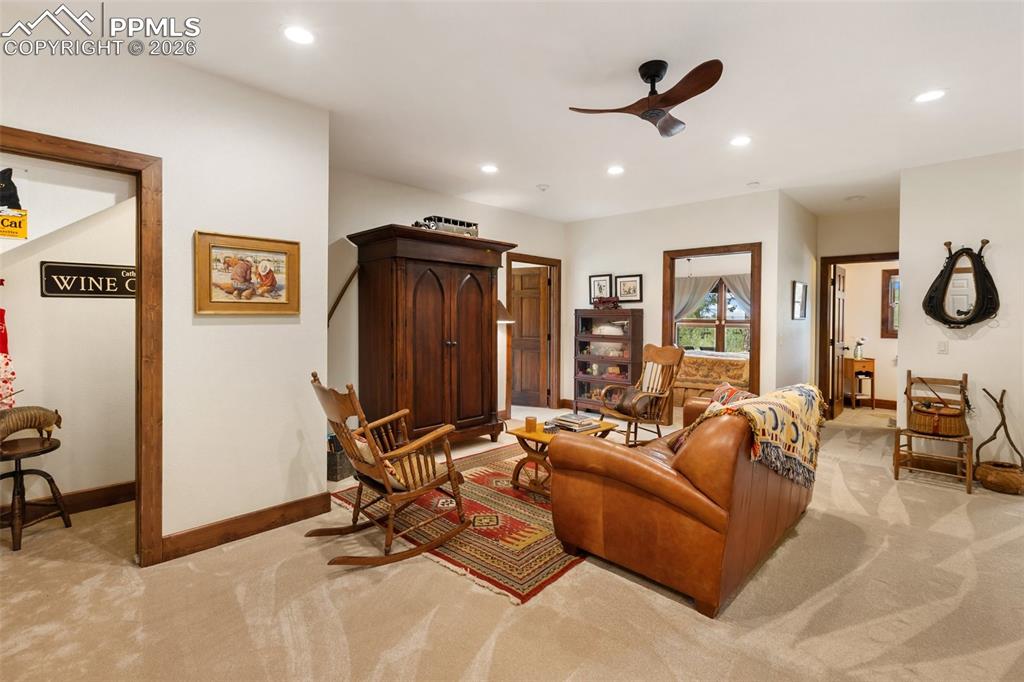 Image 33 of 48: Primary bedroom with sitting space. Main level.