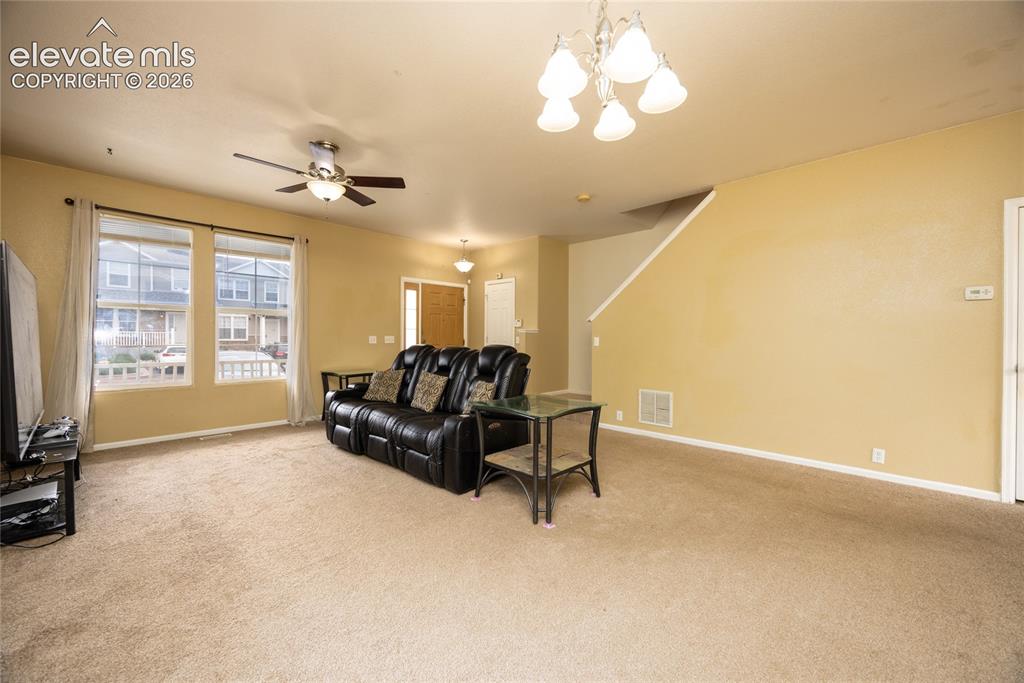 Image 6 of 26: Living room, dining room front door and stairs