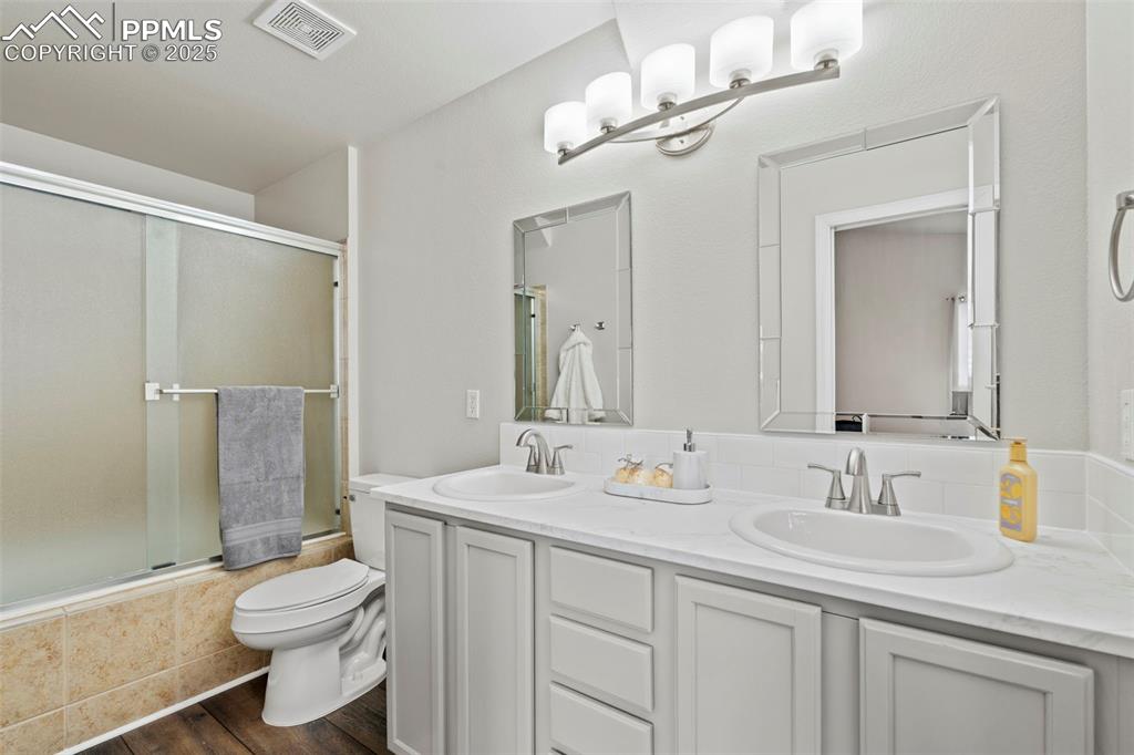 Image 23 of 42: New toilet here as well, new lighting, new mirrors, LVP throughout