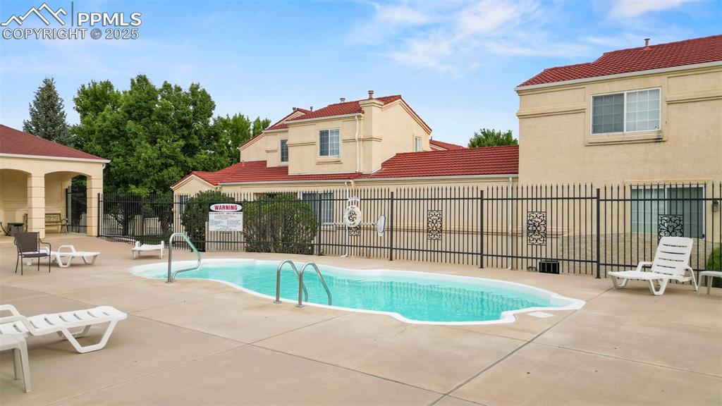 Image 38 of 42: Community pool featuring a patio area