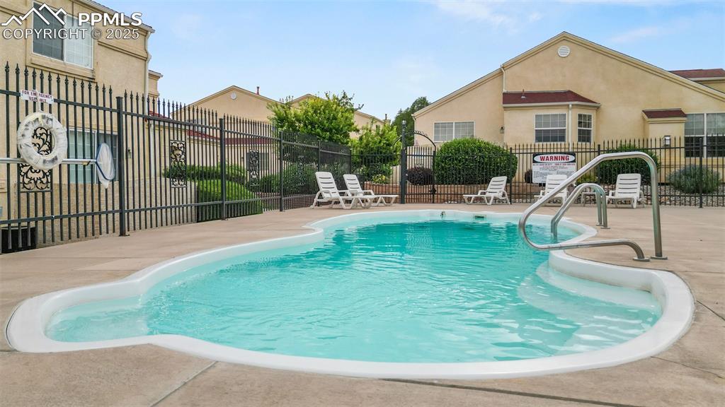 Image 39 of 42: Community pool featuring a patio area. Did I mention clean?