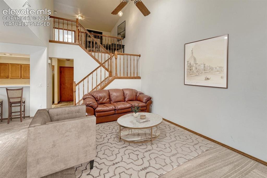 Image 17 of 50: Vaulted ceiling with skylights illuminate the living room. Virtually staged