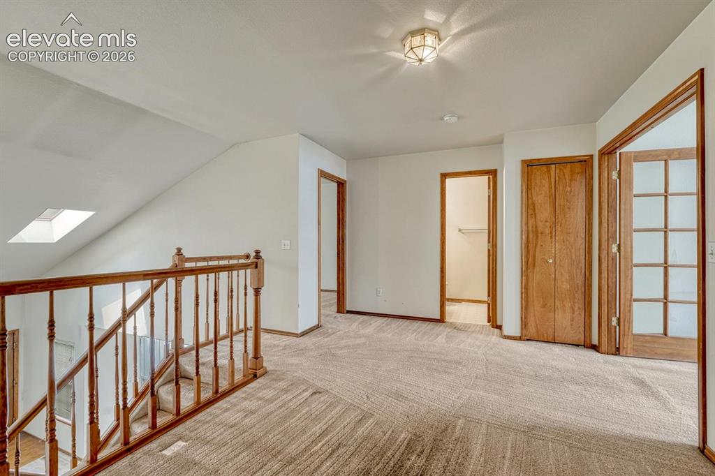 Image 19 of 50: Spacious loft overlooks the living room. Virtually staged.