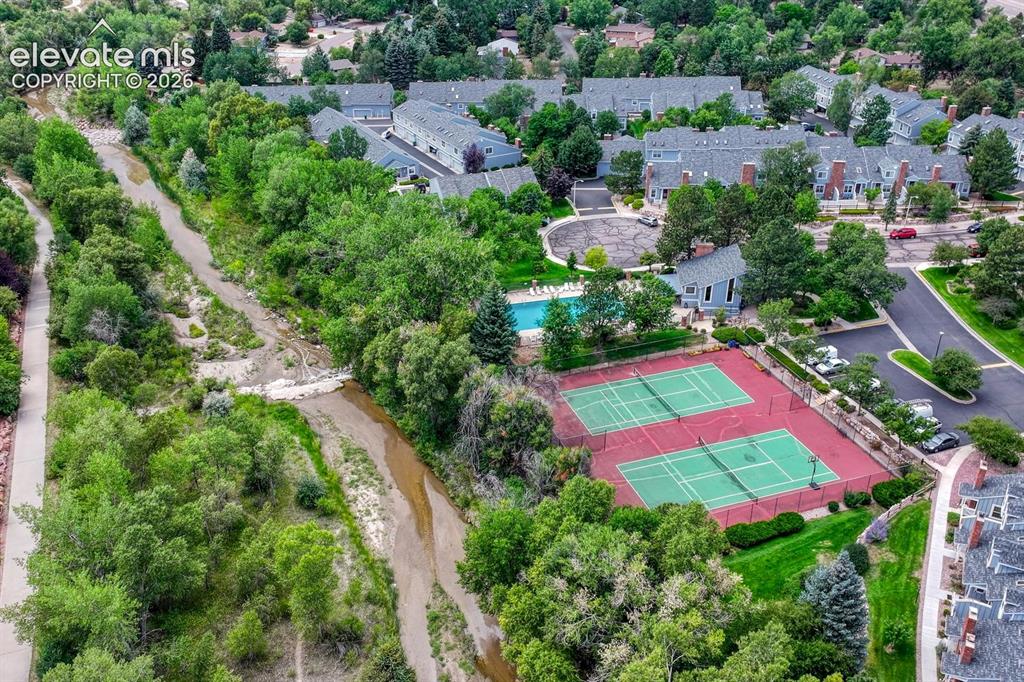 Image 40 of 50: HOA community center, pool, and tennis courts
