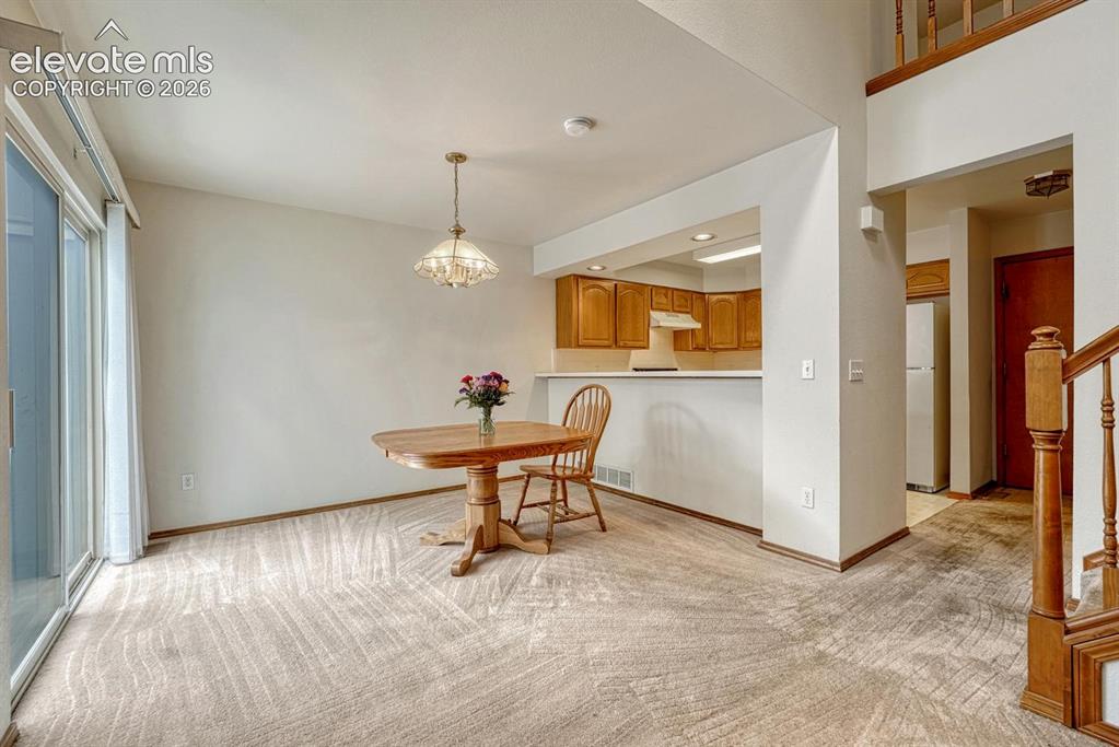 Image 7 of 50: Dining area with pass through to kitchen