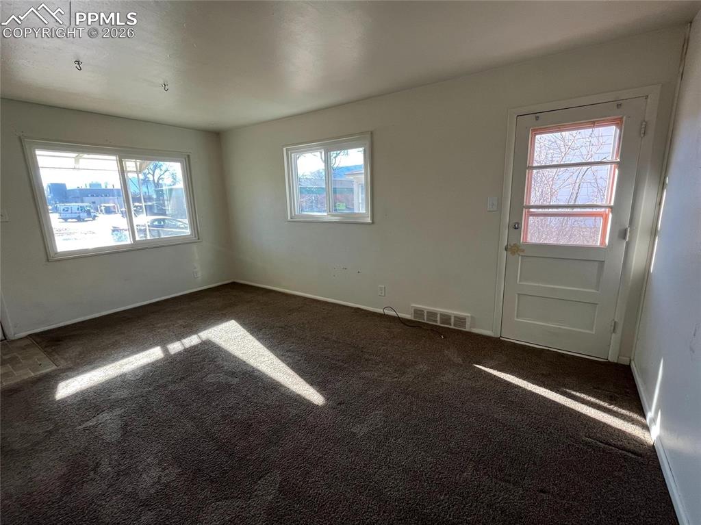 Image 10 of 15: Living room with front windows out to the street
