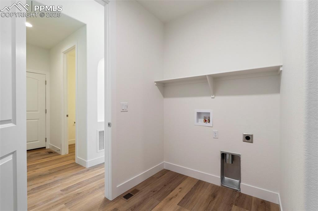 Image 32 of 34: Laundry room featuring hookup for a washing machine, light wood finished fl