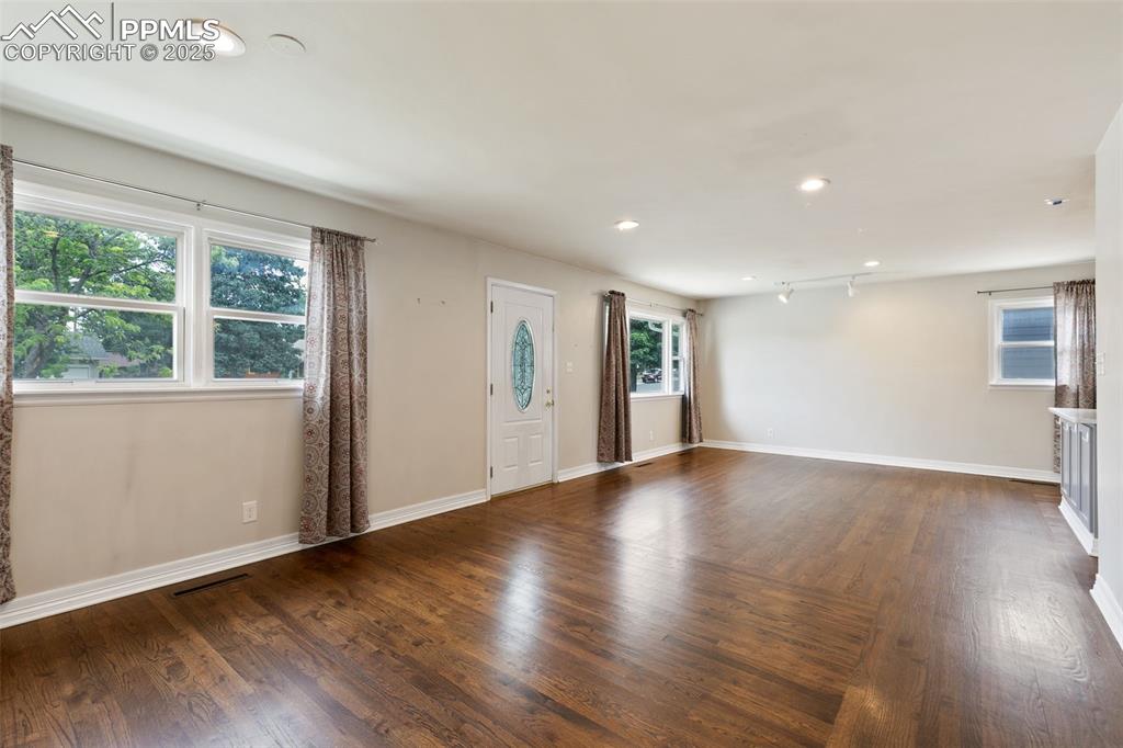 Image 11 of 36: Foyer with dark wood finished floors and recessed lighting