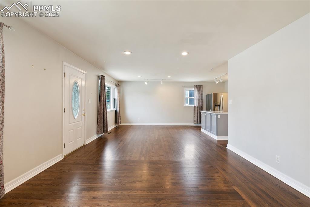 Image 15 of 36: Entryway featuring dark wood-style flooring, track lighting, and recessed l