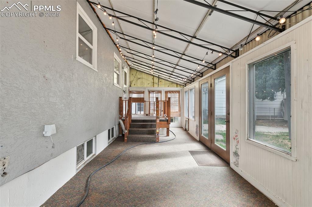 Image 16 of 36: Unfurnished sunroom with lofted ceiling