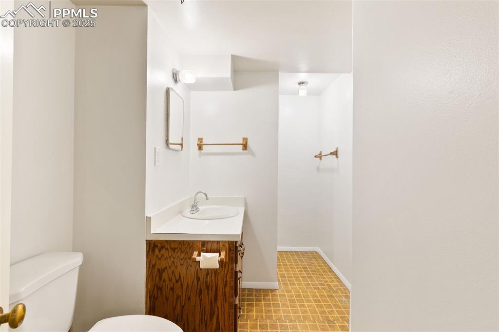 Image 28 of 36: Bathroom with toilet and vanity