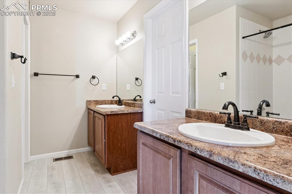 Image 11 of 29: Full bathroom with two vanities