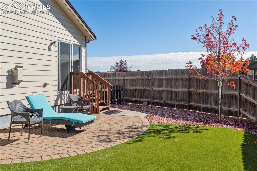 Image 21 of 29: Private backyard with patio and low maintenance turf
