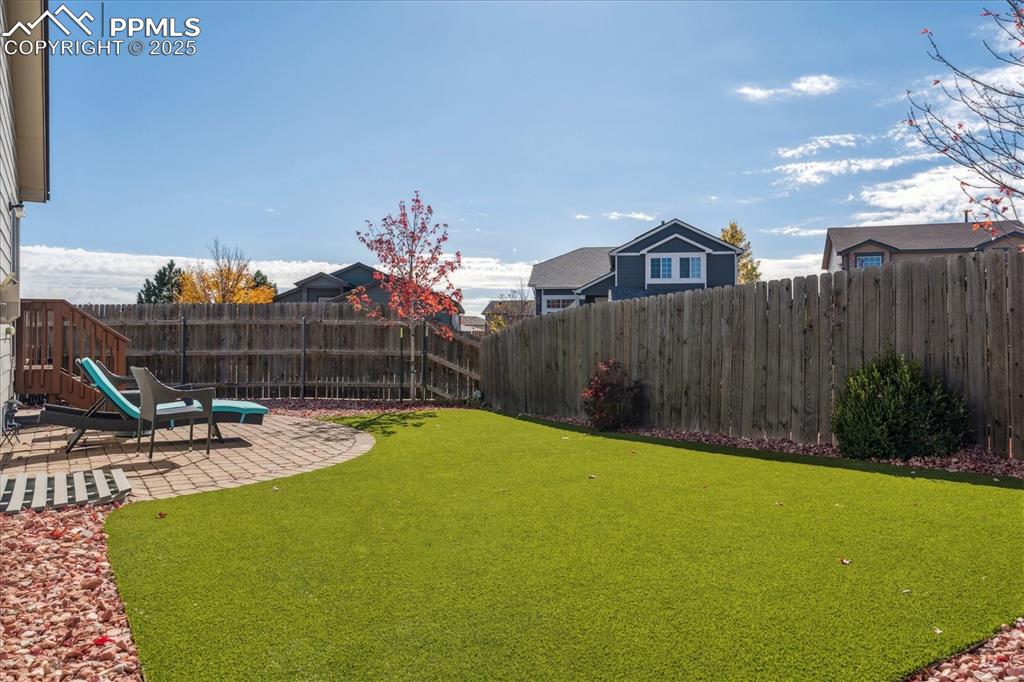 Image 22 of 29: Private backyard with patio and low maintenance turf