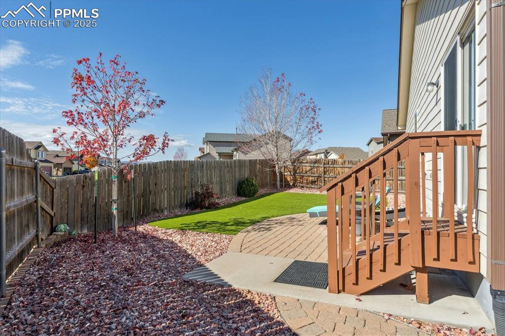 Image 23 of 29: Private backyard with patio and low maintenance turf