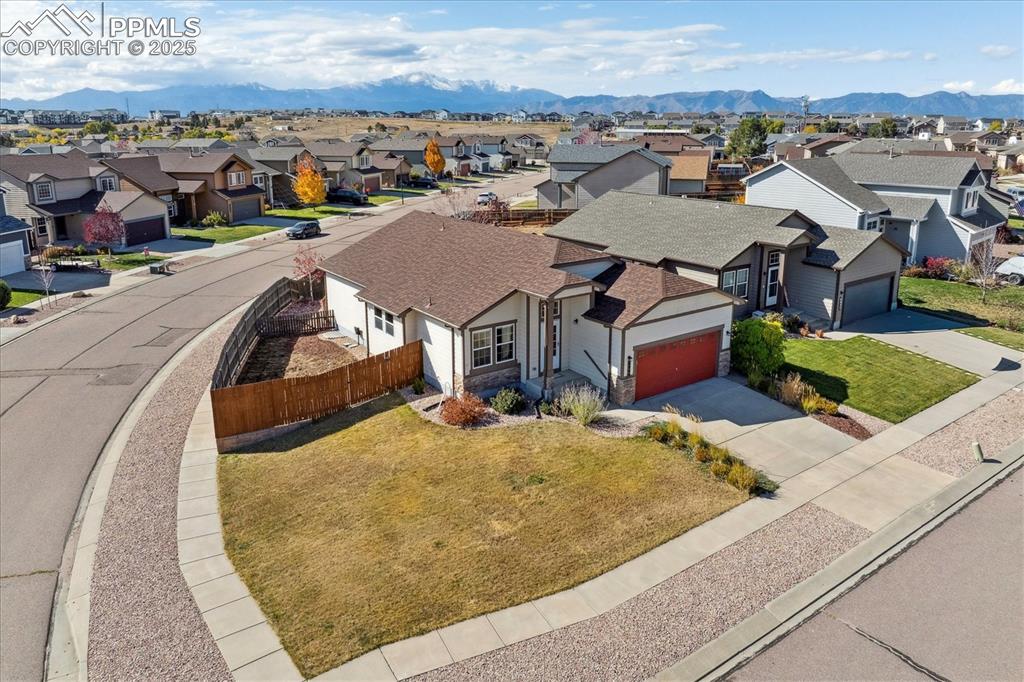 Image 27 of 29: Aerial perspective of suburban area featuring mountains