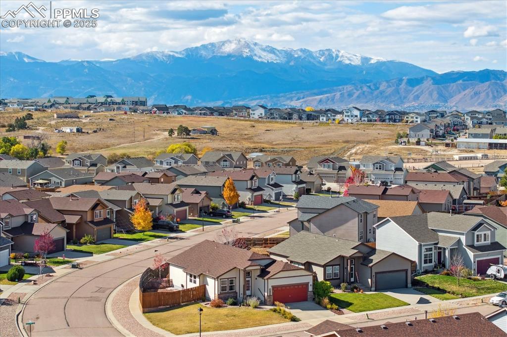 Image 29 of 29: Aerial perspective of suburban area featuring a mountain backdrop